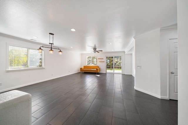 unfurnished living room featuring ceiling fan and ornamental molding