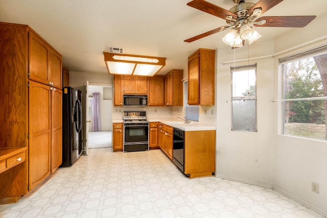 kitchen featuring sink, black appliances, and ceiling fan