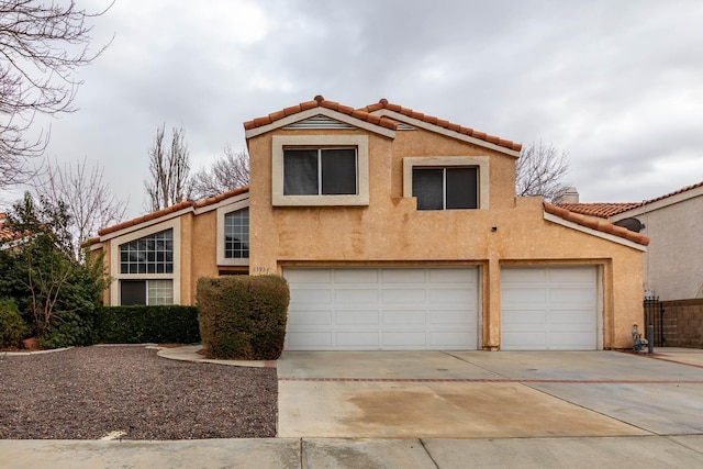 mediterranean / spanish home with a garage