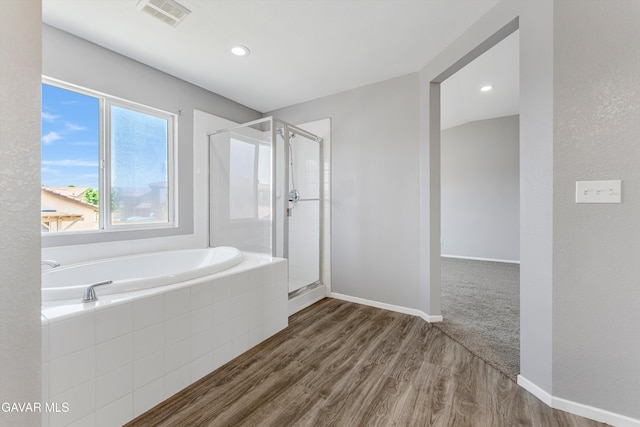 4614 Stillmeadow Ln, Lancaster, CA 93536 - bathroom featuring a garden tub, a shower stall, wood finished floors, and baseboards