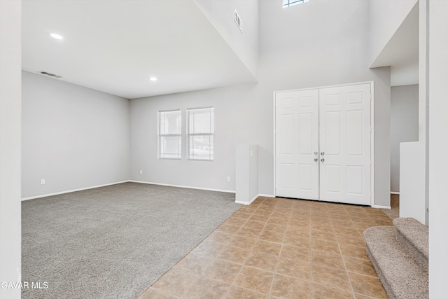 4614 Stillmeadow Ln, Lancaster, CA 93536 - carpeted entrance foyer with baseboards, recessed lighting, tile patterned flooring, and a high ceiling