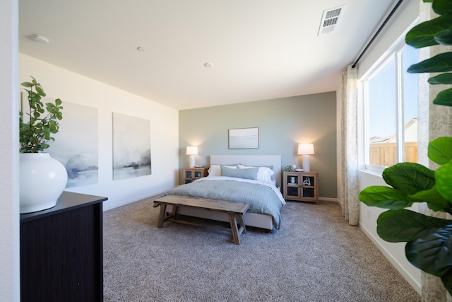 carpeted bedroom with visible vents and baseboards