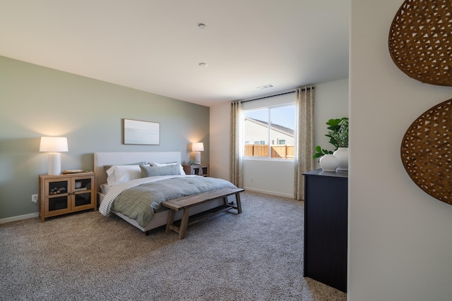 carpeted bedroom with baseboards and visible vents