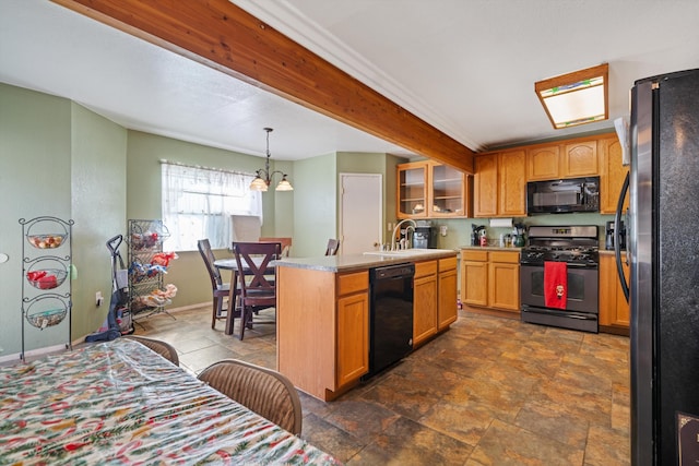 kitchen with light countertops, glass insert cabinets, a sink, black appliances, and baseboards