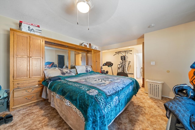 bedroom with a ceiling fan and light colored carpet