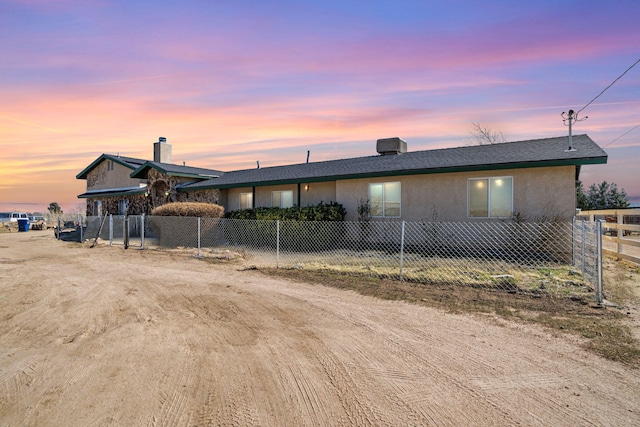 view of front of property featuring a fenced front yard and stucco siding