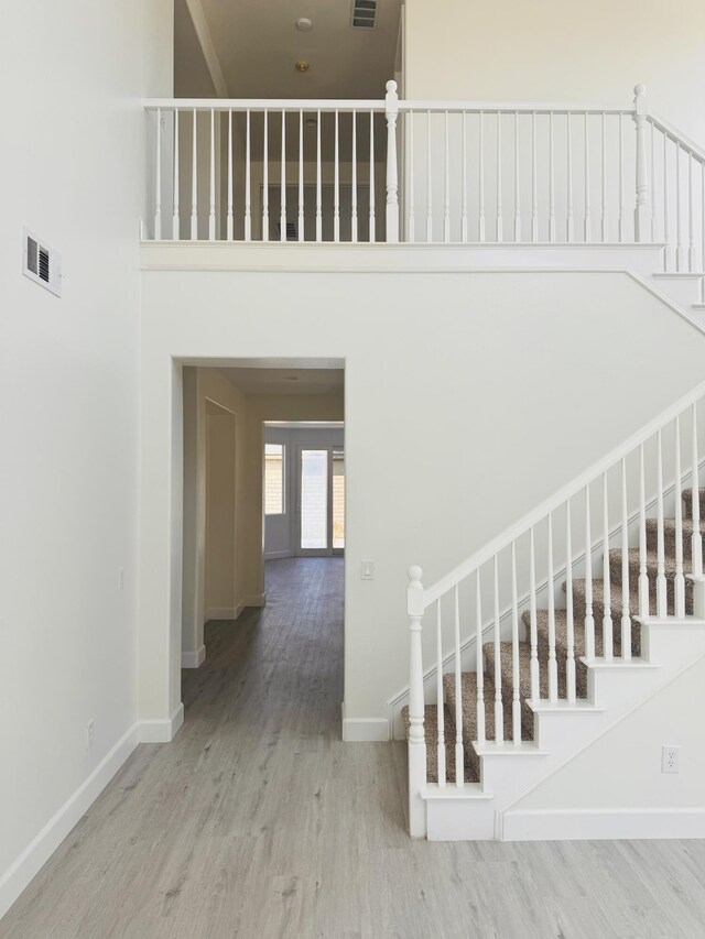 44838 Lotus Ct, Lancaster, CA 93536 - stairway featuring baseboards, visible vents, and wood finished floors