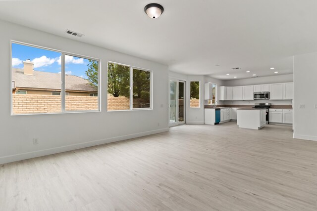 44838 Lotus Ct, Lancaster, CA 93536 - unfurnished living room featuring baseboards, recessed lighting, visible vents, and light wood-type flooring