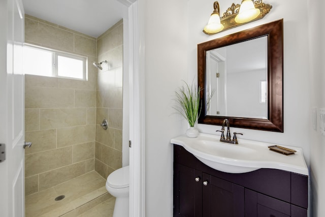 bathroom with toilet, a stall shower, and vanity