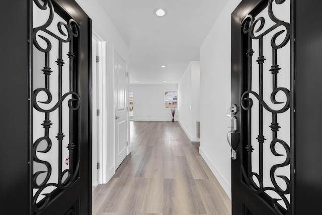 entrance foyer with recessed lighting, light wood-type flooring, and baseboards