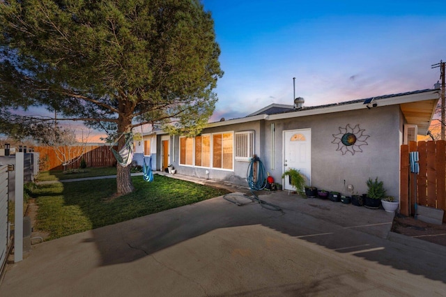 ranch-style house featuring a lawn