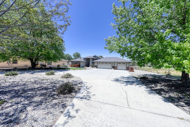view of front of property featuring a garage and concrete driveway