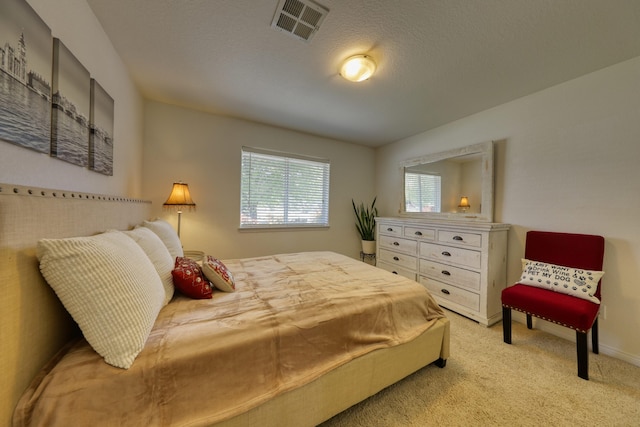 bedroom with light carpet and baseboards
