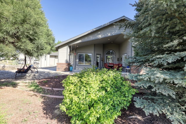 rear view of property with brick siding