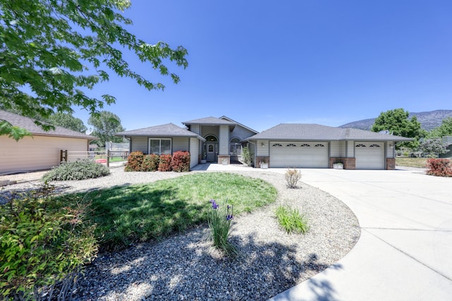 ranch-style home with an attached garage, brick siding, driveway, and fence