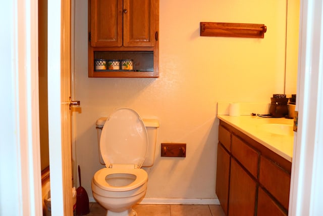 bathroom featuring tile patterned flooring, vanity, and toilet