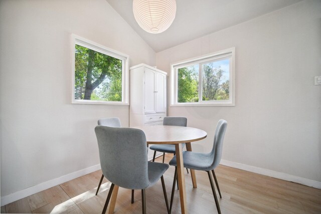 18133 Ellstree Dr, Lake Hughes, CA 93532 - dining area with light wood-style flooring, baseboards, and vaulted ceiling