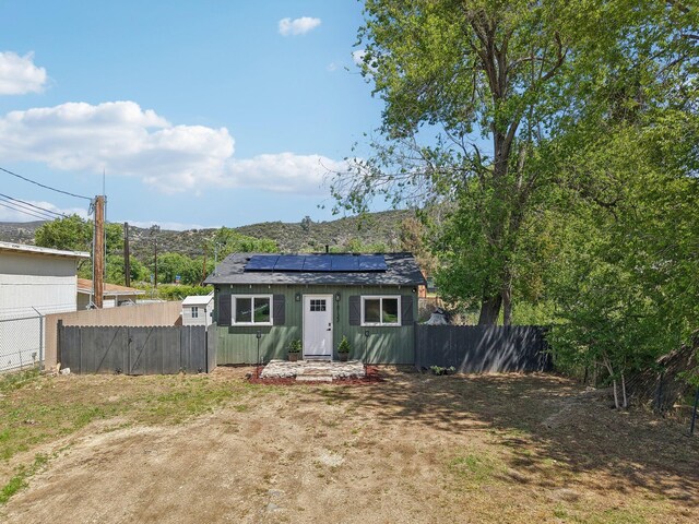 18133 Ellstree Dr, Lake Hughes, CA 93532 - rear view of property with solar panels and fence