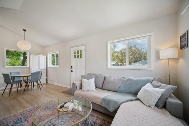 18133 Ellstree Dr, Lake Hughes, CA 93532 - living room featuring light wood-type flooring, baseboards, and vaulted ceiling