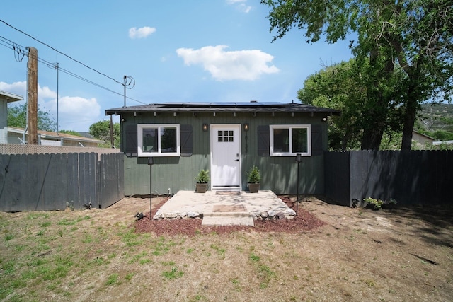 18133 Ellstree Dr, Lake Hughes, CA 93532 - back of property featuring a fenced backyard and roof mounted solar panels