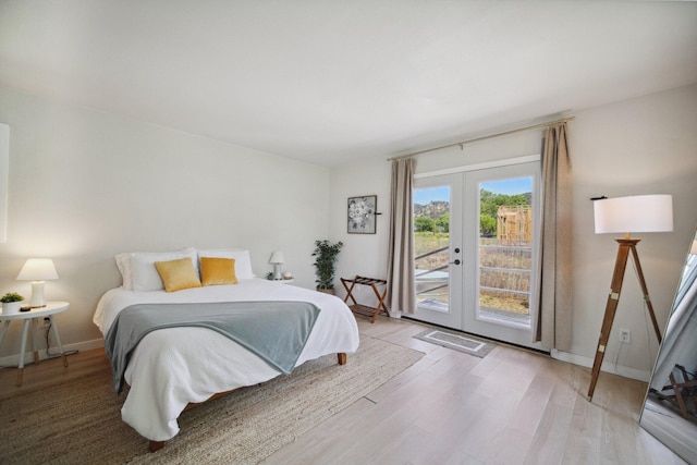 18133 Ellstree Dr, Lake Hughes, CA 93532 - bedroom featuring access to exterior, french doors, light wood-style floors, and baseboards