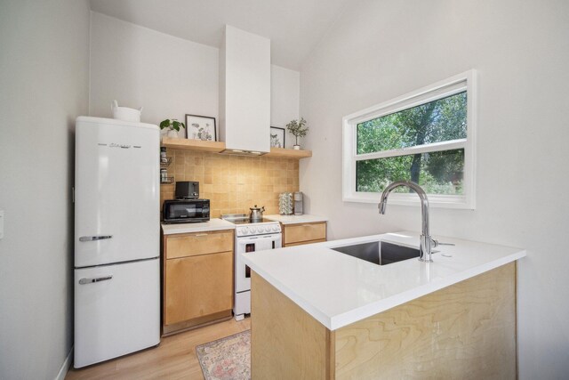 18133 Ellstree Dr, Lake Hughes, CA 93532 - kitchen featuring white appliances, a sink, open shelves, light wood-style floors, and decorative backsplash