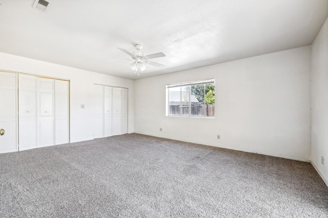 3112 Echo Dr, Rosamond, CA 93560 - unfurnished bedroom with two closets, carpet, and ceiling fan