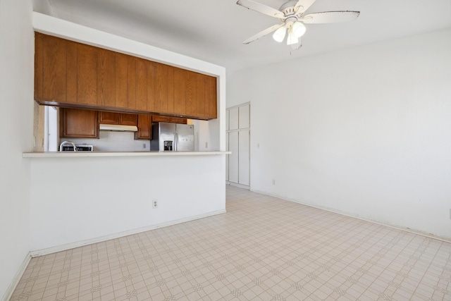 3112 Echo Dr, Rosamond, CA 93560 - kitchen with stainless steel fridge with ice dispenser, brown cabinets, ceiling fan, light flooring, and light countertops