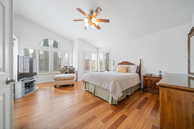 bedroom featuring hardwood / wood-style flooring, vaulted ceiling, and ceiling fan