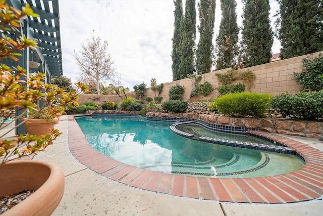 view of swimming pool with an in ground hot tub