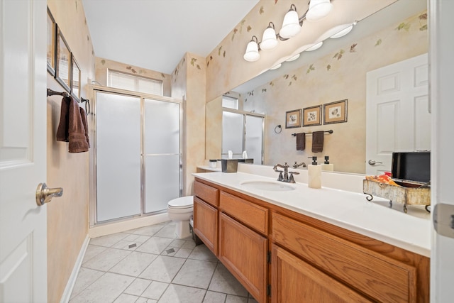 bathroom with tile patterned floors, vanity, toilet, and a shower with door