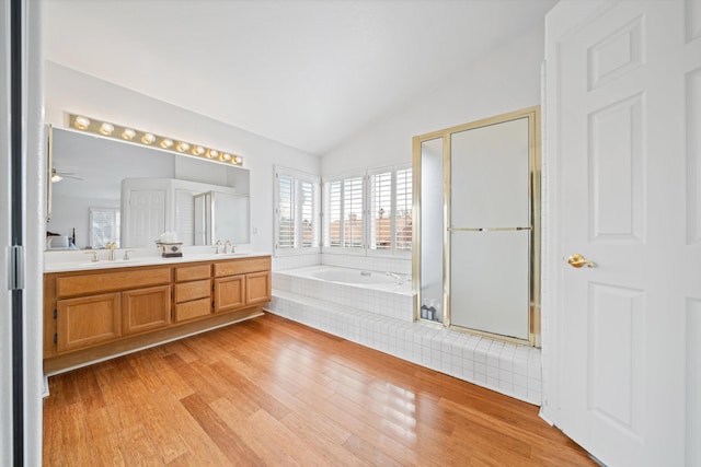 bathroom featuring lofted ceiling, shower with separate bathtub, wood-type flooring, and vanity