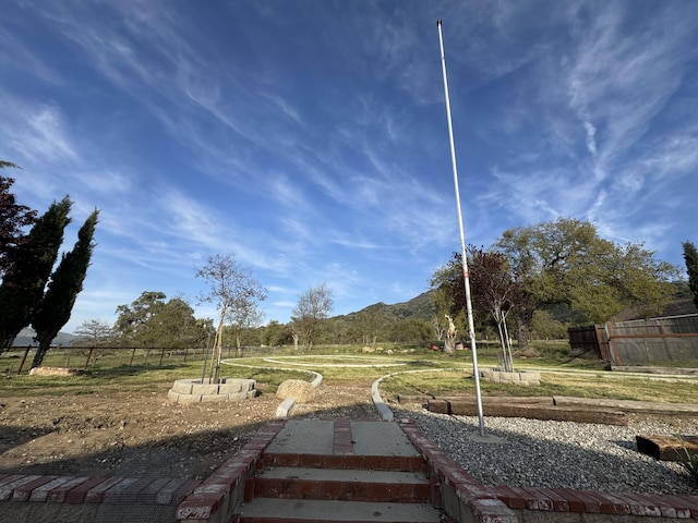 view of yard with a mountain view and fence
