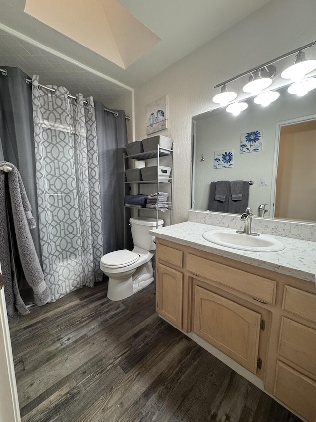 bathroom featuring vanity, a shower with curtain, toilet, and wood finished floors