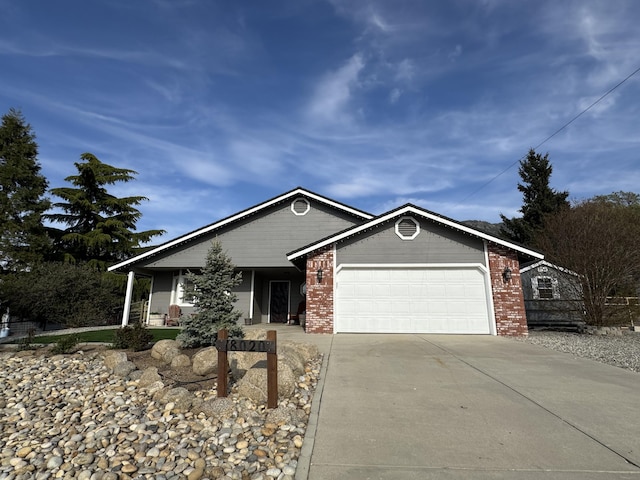 view of front facade with an attached garage, driveway, and brick siding