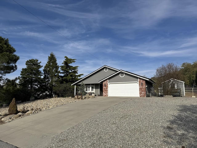 view of front of home with an attached garage, driveway, and brick siding