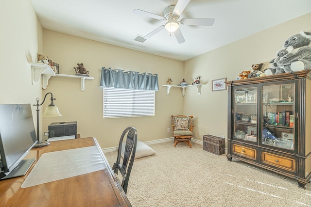 carpeted office space with ceiling fan