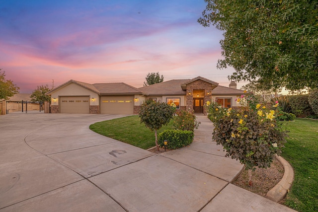 view of front of house featuring a garage and a lawn