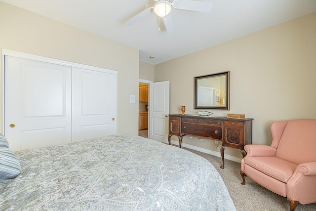 bedroom featuring ceiling fan, light colored carpet, and a closet