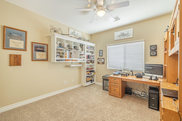 carpeted office space featuring ceiling fan