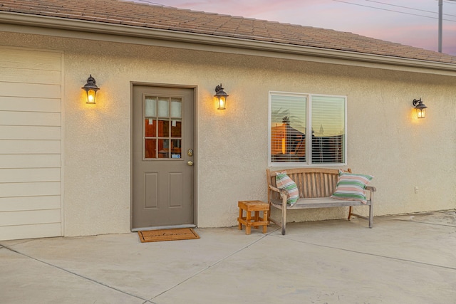 view of exterior entry at dusk