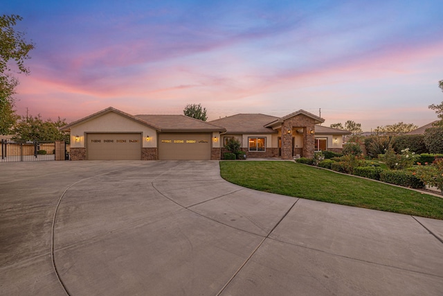 view of front facade with a lawn and a garage