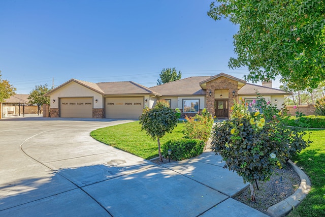 view of front of house with a front yard and a garage