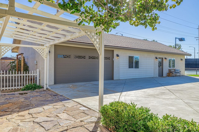 ranch-style home featuring a pergola and a garage