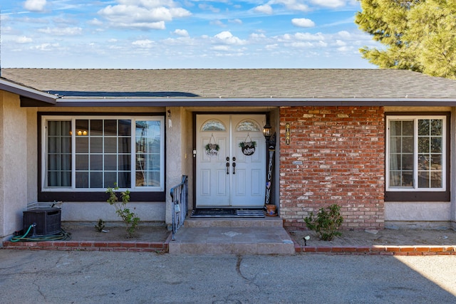 doorway to property featuring central AC unit