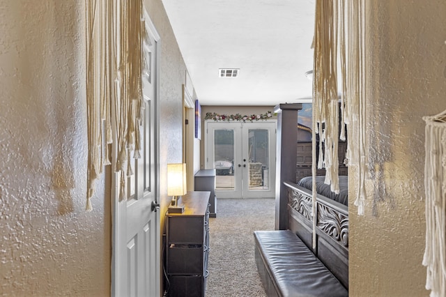 corridor with french doors and carpet floors