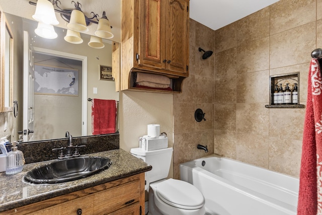 full bathroom with tiled shower / bath, vanity, and toilet