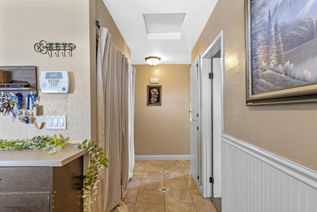 hallway with light tile patterned floors