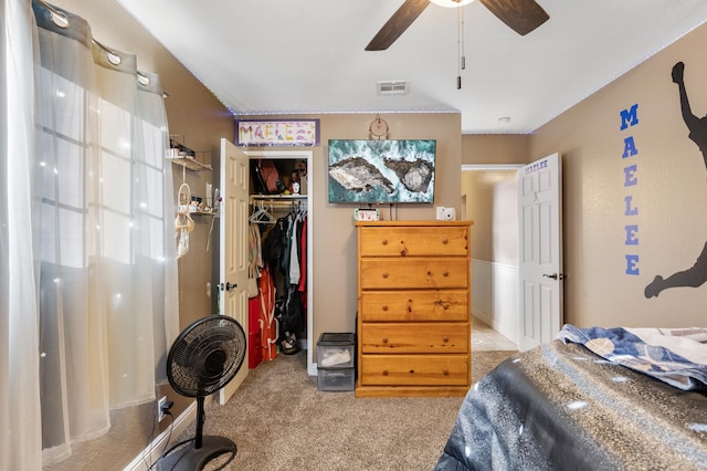 bedroom featuring light carpet, a closet, and ceiling fan