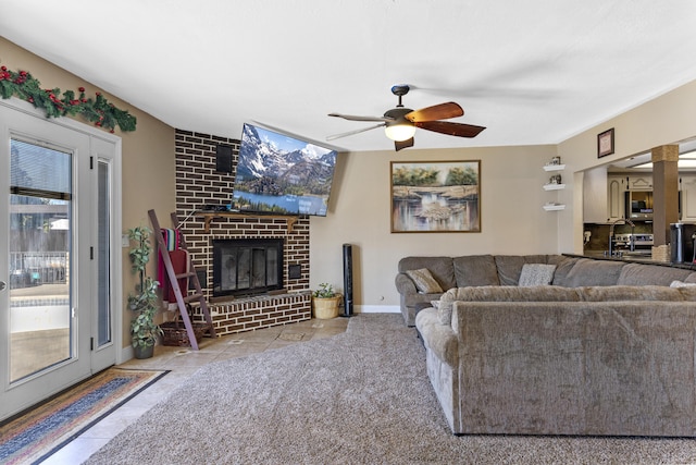 living room featuring ceiling fan, light tile patterned floors, and a fireplace